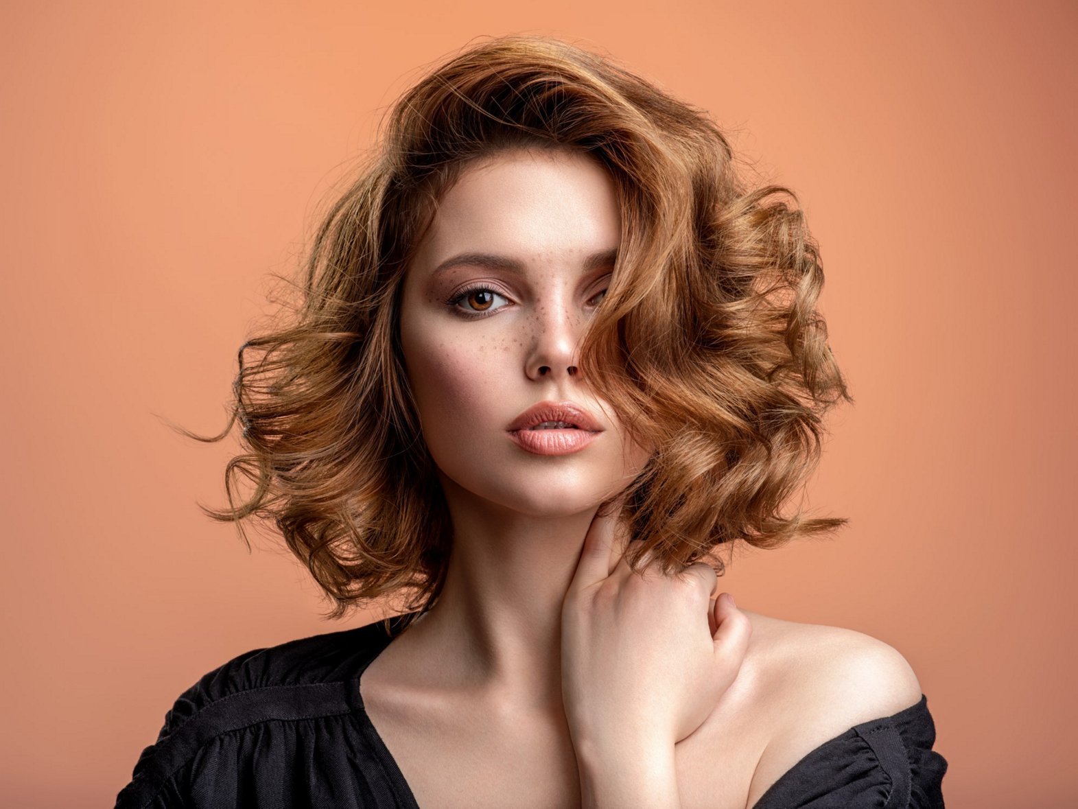 Woman with auburn hair with a bob in a side parting