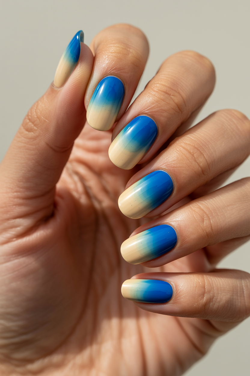 Blue-to-Cream Gradient nail design — A full ombré from blue at the tip to cream at the cuticle, no hard line anywhere.