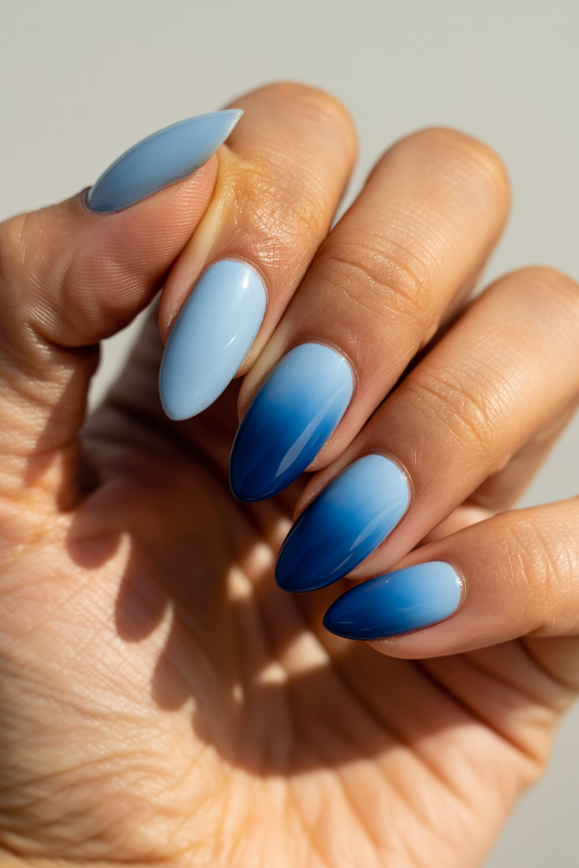 Ocean Blue Ombré nail design — Pale sky blue at the cuticle deepening to navy at the tip.
