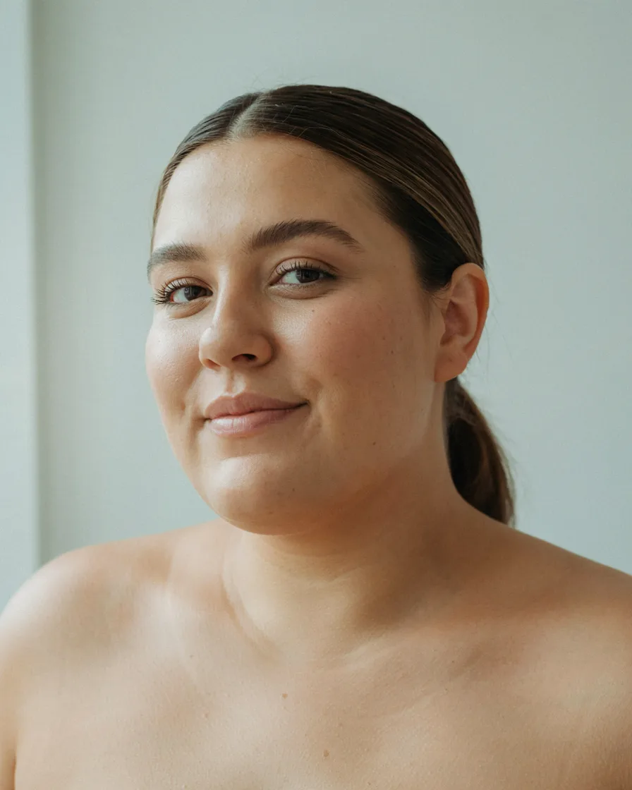 Sleek Low Ponytail with a Side Part hairstyle for a chubby face