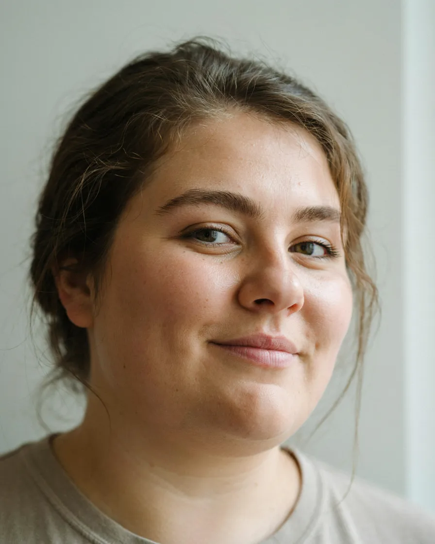 Messy Low Bun with Loose Pieces hairstyle for a chubby face