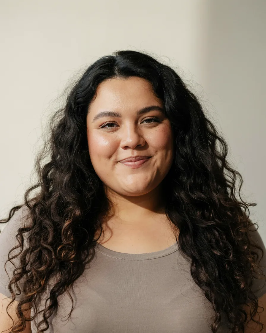 Voluminous Curls with a Side Part hairstyle for a chubby face